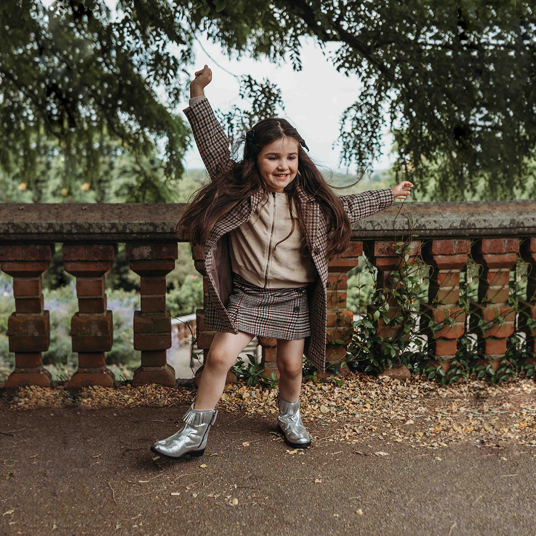 Little girl dancing wearing Pip and Henry Silver Western Boots