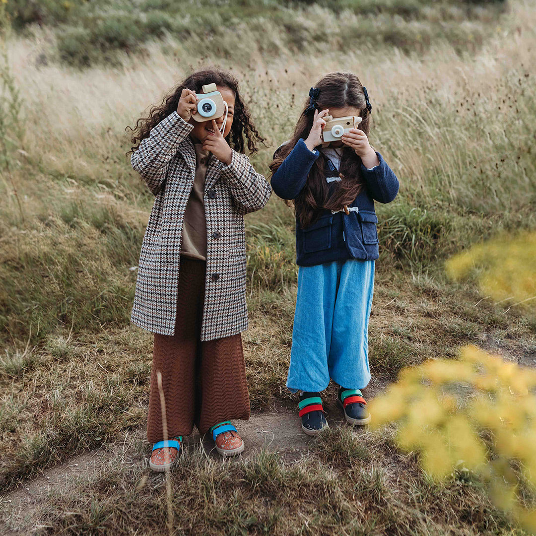 two girls holding cameras wearing Pip and Henry Sneakers